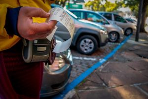 Mulher retirando comprovante de cobrança do Rapidinho